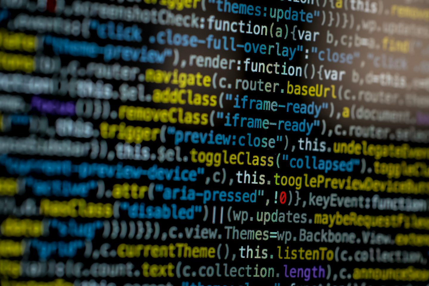 Computer code with colorful programming elements on a dark screen.